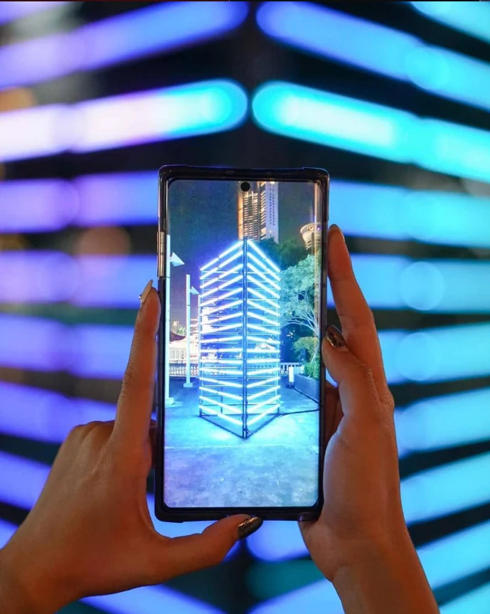 Interactive light installation photographed through a mobile phone in Bangkok